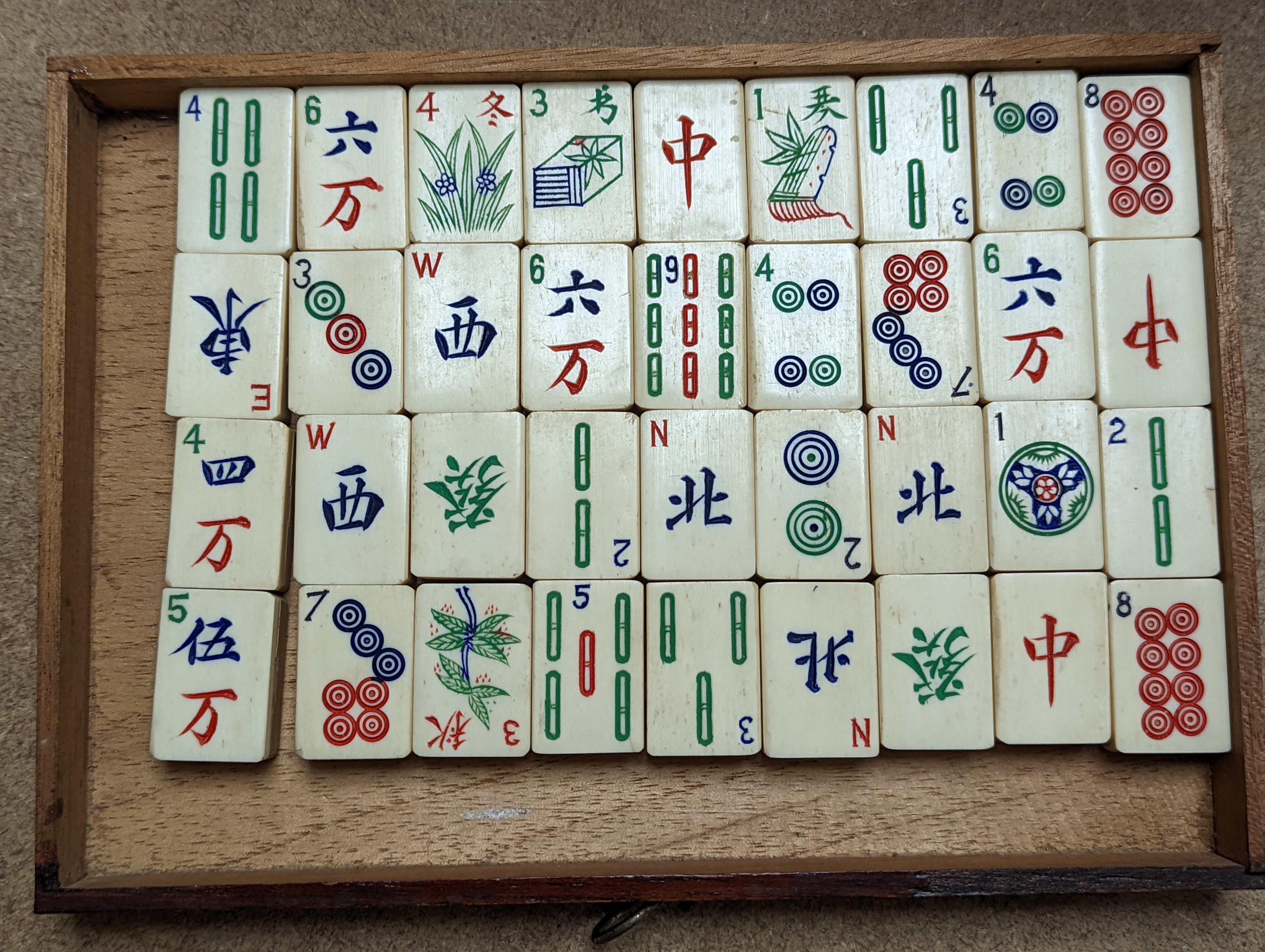 A Mah Jong set in wooden box, 17 cms high.